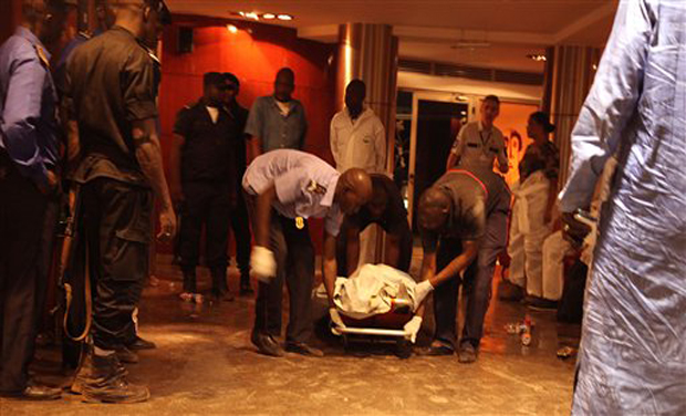 Mali security personal pick up the lifeless body of a victim inside the Radisson Blu hotel after an attack by gunmen (Photo: AP) Mali security personal pick up the lifeless body of a victim inside the Radisson Blu hotel after an attack by gunmen (Photo: AP)